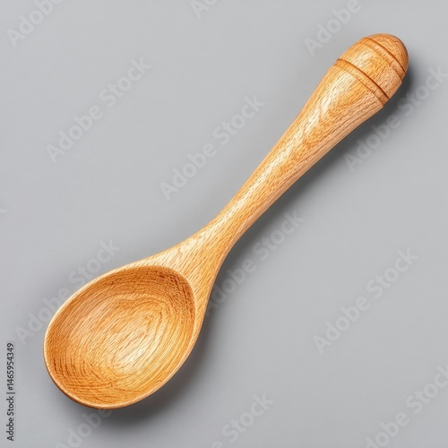 Obraz na płótnie Small Light Brown Wooden Spoon on Gray Background w salonie