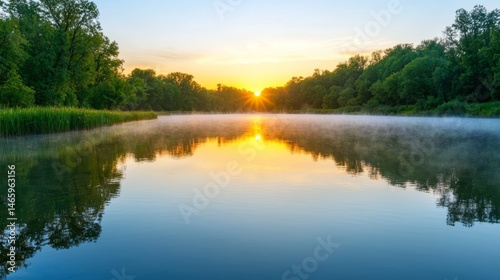 Serene Sunrise Over a Foggy Reflective Lake