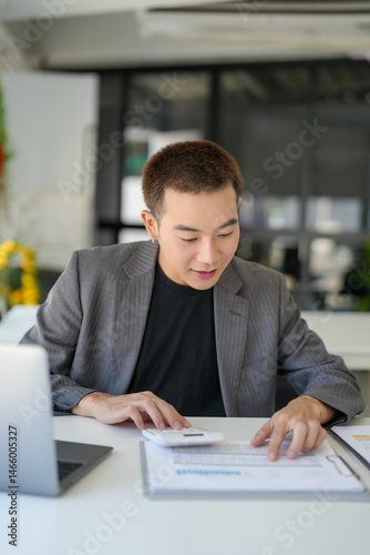 Confident asian business man Auditor or internal revenue service staff checking annual financial statements company Audit  Accounting tax. photo