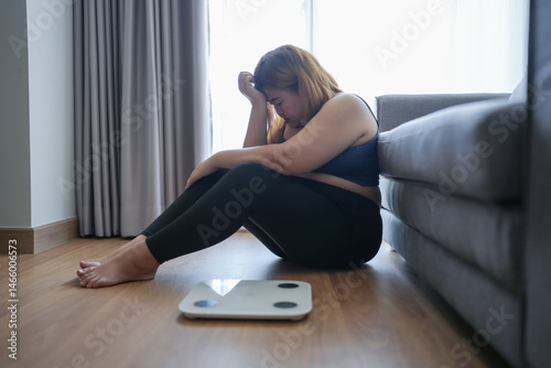 Obraz na plátně Sad woman with fat upset bored of dieting Weight loss fail  Fat diet and scale sad asian woman on weight scale at home weight control