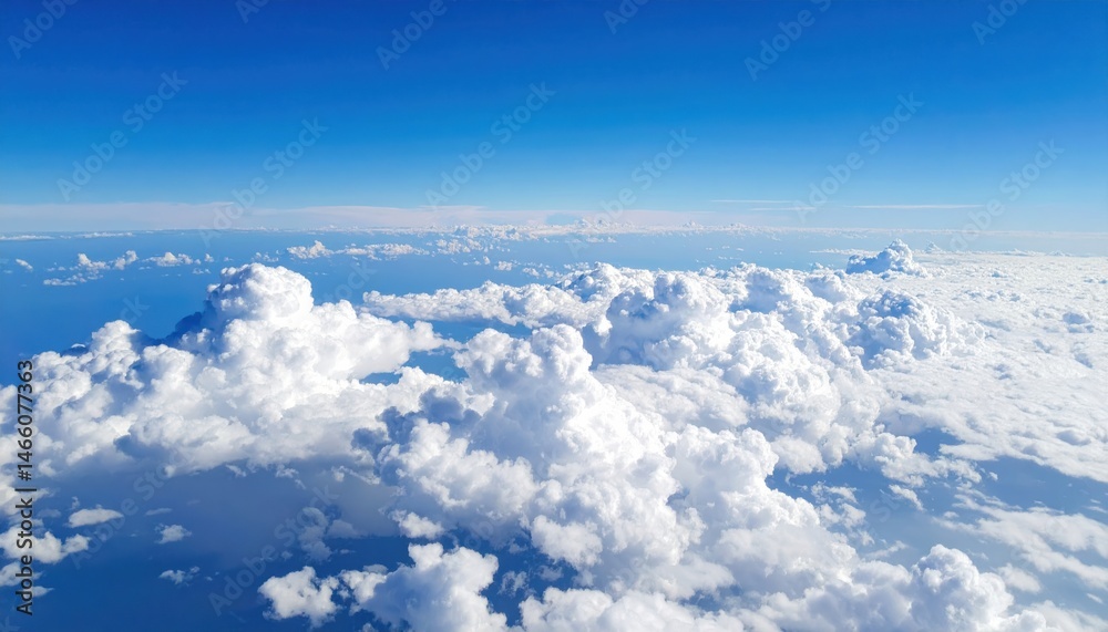 Naklejka premium A stunning aerial view of fluffy white clouds against a vibrant blue sky, creating a serene and peaceful atmosphere