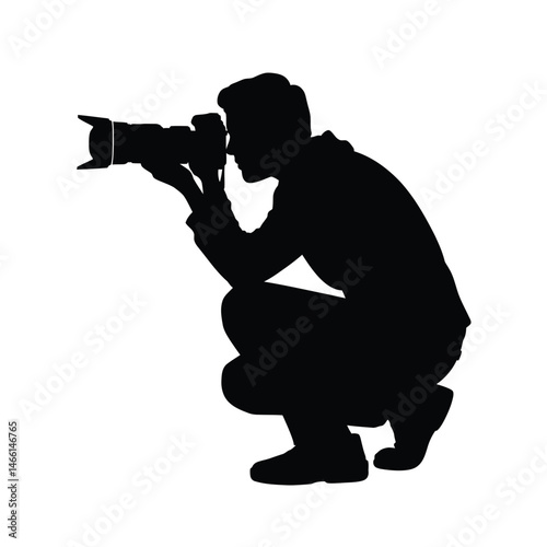 Silhouette of a Photographer Crouching and Taking a Picture