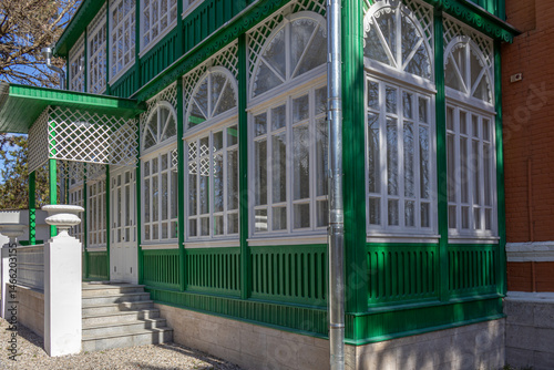An old brick mansion with a wooden veranda, built in the 19th century. A large old house with a garden in the Caucasus. There is a literary museum in the old building. Renovated old mansion.