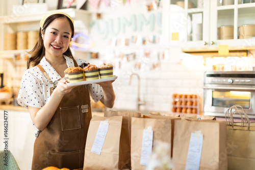 Small business owners are selling .Asian bakery  cake shop owner enjoy posting picture and review her cake on social media or online marketing streaming publish for advertising small business making m