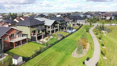 Residential neighborhood with houses and a park. The houses are mostly white and the park is green