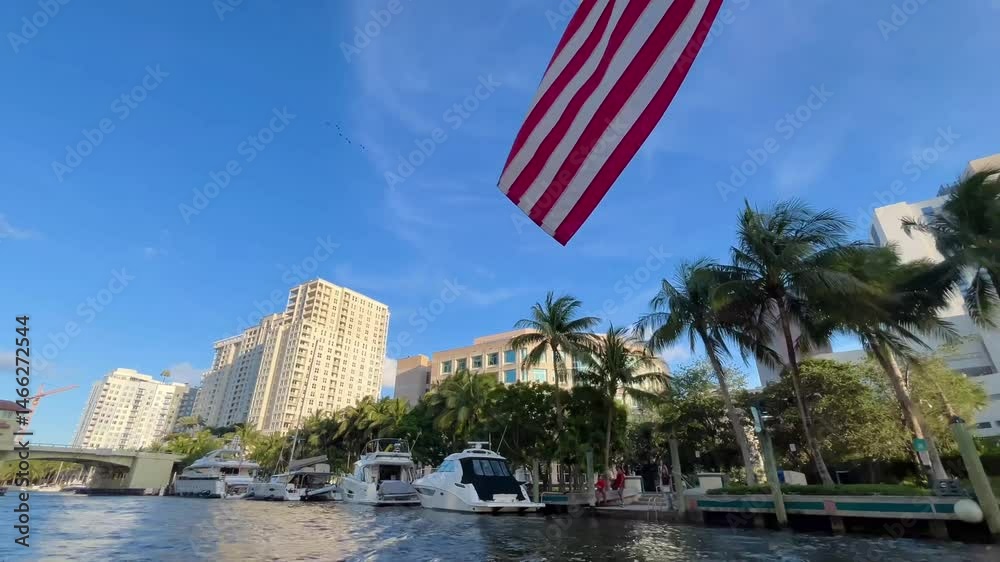 Yachts and Sailboats on Intracoastal Waterway and modern buildings rising in Fort Lauderdale, Florida in a sunset day.