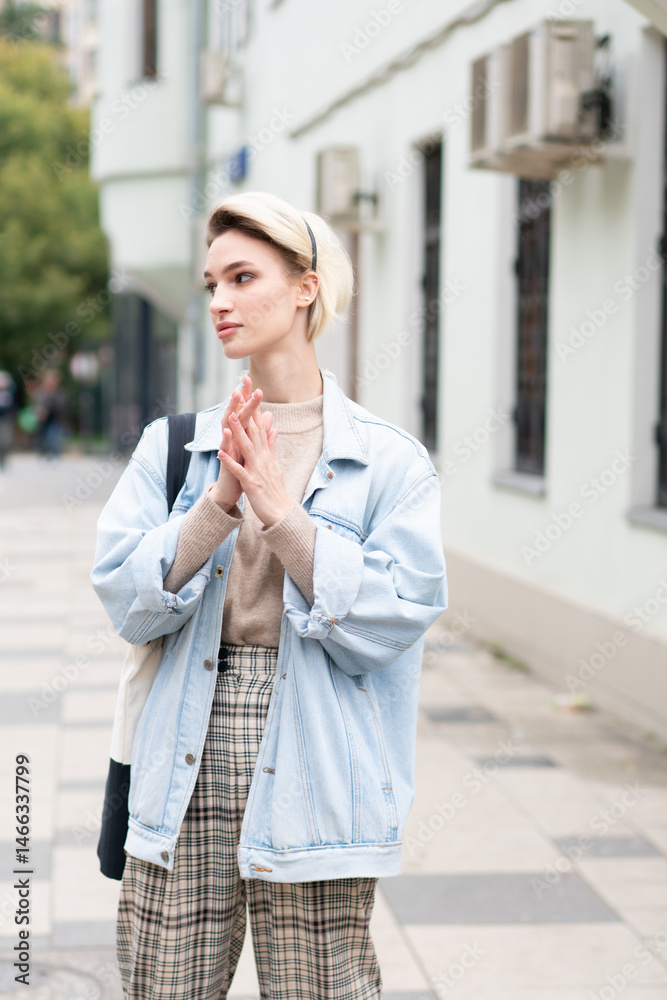 Fototapeta premium young beautiful woman posing in blue jacket outside