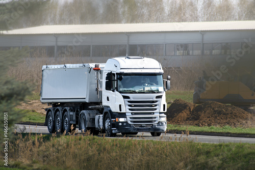 White commercial truck traveling on transit route