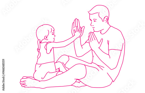  Father and daughter playing patty-cake at home.