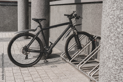 Side view of a black bicycle parked on a city street.