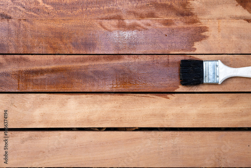 Obraz na plátne Paint brush apply varnish on new surface of lumber, wood product in top view