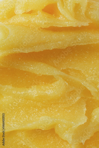 Abstract yellow sugar body exfoliating scrub texture. Melon scrub for body or face pilling. Skin care body moisturizer scrub background.