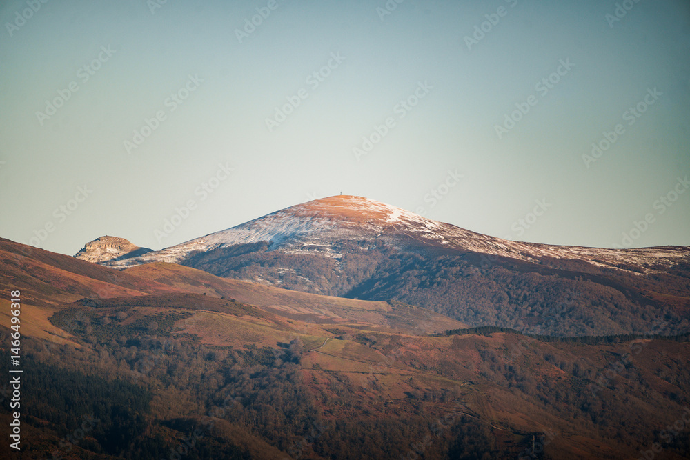 Fototapeta premium Majestic gorbea mountain glowing under a clear blue sky in the beautiful region of aiaraldea, basque country, spain