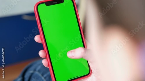 Close up of a woman's hand holding a mobile telephone with a vertical green screen in car chroma key smartphone technology cell phone street touch message display hand