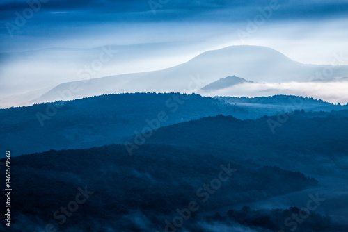 Fototapeta Naklejka Na Ścianę i Meble -  Montains in the mornig mist, blue landscape
