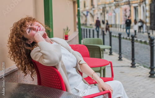 Smiling Redhead Woman in City. Candid Moments. Lady  in her late 30s or early 40s, smiling sincerely in an urban setting