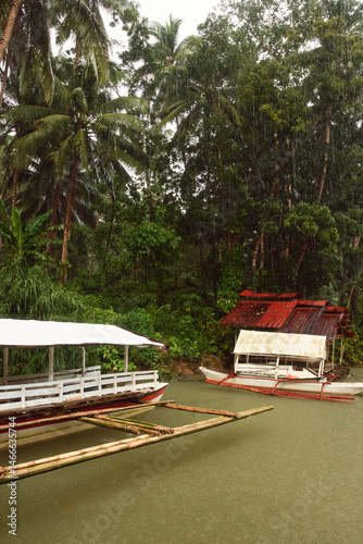 Fototapeta Naklejka Na Ścianę i Meble -  
Bohol, Philippines - December 23, 2024: Cruise ship on the Loboc River is a river in the Bohol province of the Philippines. It is one of the major tourist destinations of Bohol. During heavy rain.
