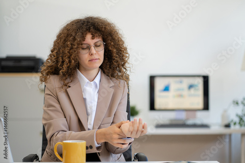 Female businessman is doing a stretchy posture due to sitting in the office for too long, office syndrome concept. photo