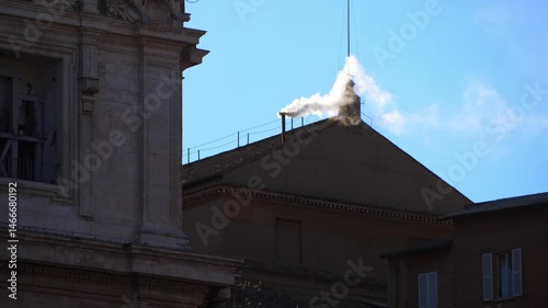 Rome, Italy - May 8, 2025: White smoke rises clearly from the Sistine Chapel chimney, marking the election of the new pope as people in the square cheer in celebration.
