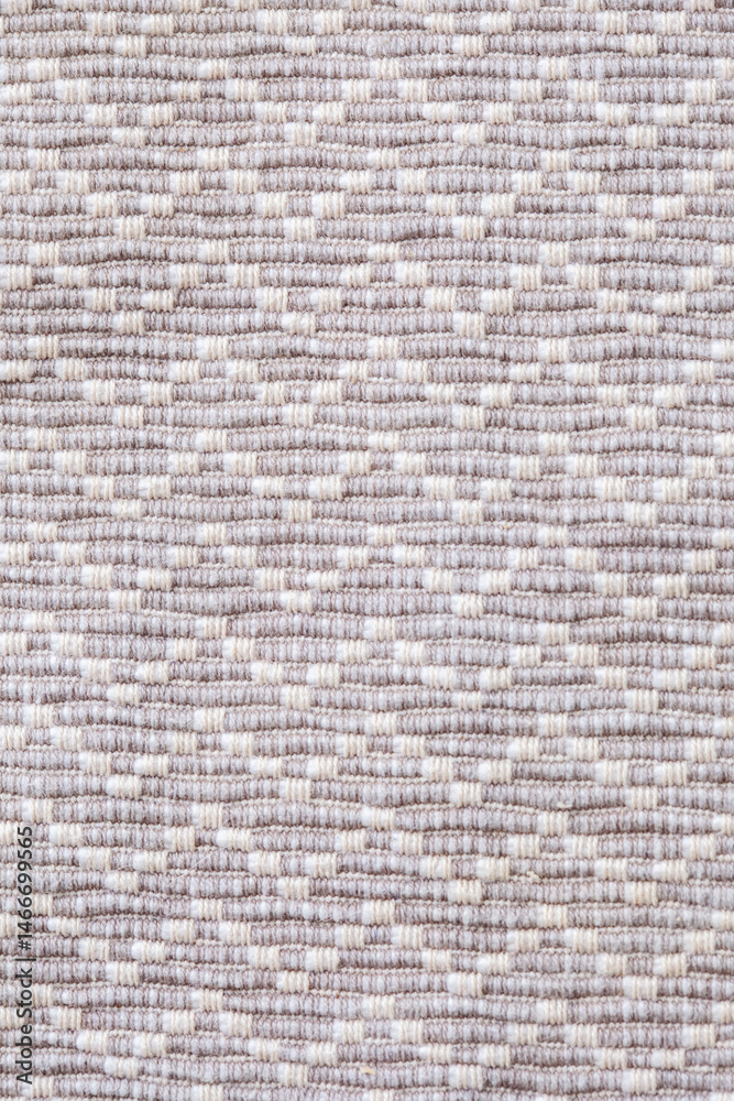 Fototapeta premium Close up of a patterned carpet with white and gray colors