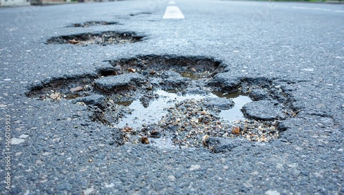 Damaged city street with potholes