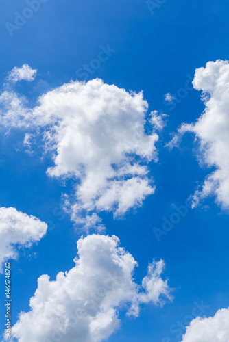 Bright blue sky with fluffy white clouds.