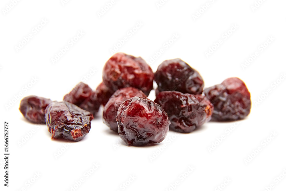 Group of multiple dried cranberries with dark red color and glossy, wrinkled texture arranged casually on a white background for food presentation Group of multiple dried cranberries with dark red color and glossy, wrinkled texture arranged casually on a white background for food presentation