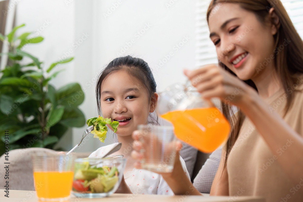 Wellness through shared cuisine: Mother and daughter enjoying fresh juice Wellness through shared cuisine: Mother and daughter enjoying fresh juice