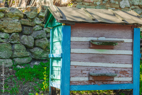 Beehives with bees flying out, set in a natural environment. Highlights global bee population