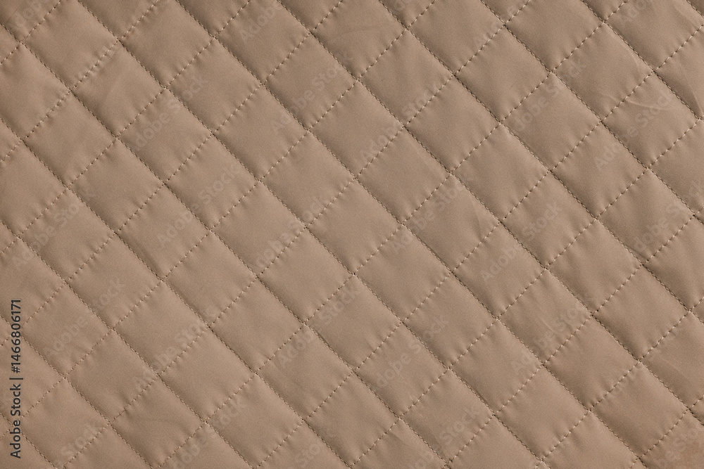 Fototapeta premium Checkered, diamond stitching pattern, brown quilted fabric background. Blanket or puffer jacket, stitch rhombus texture close up, macro. Wallpaper, backdrop.