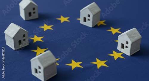 European Union Housing Market - Miniature houses arranged in a circle on a European Union flag, symbolizing housing in the EU