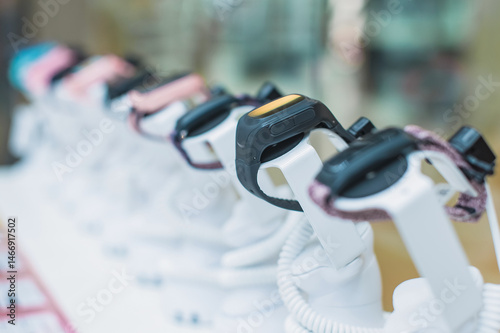 Photography Smartwatches displayed on stands in a store, close-up row.