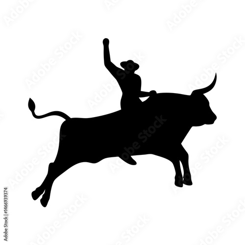 Silhouette of a cowboy riding a bucking bull, arm raised in victory