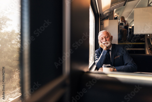 Senior Businessman Sleeping on Train During Journey