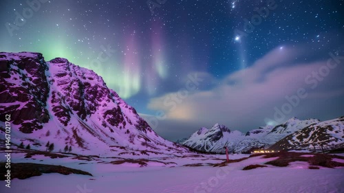 Stunning aurora borealis over snowcovered mountains at night in arctic region