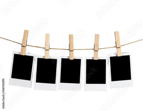 A row of five Polaroid frames pinned on a rope with clothespins showcasing simplicity and a 