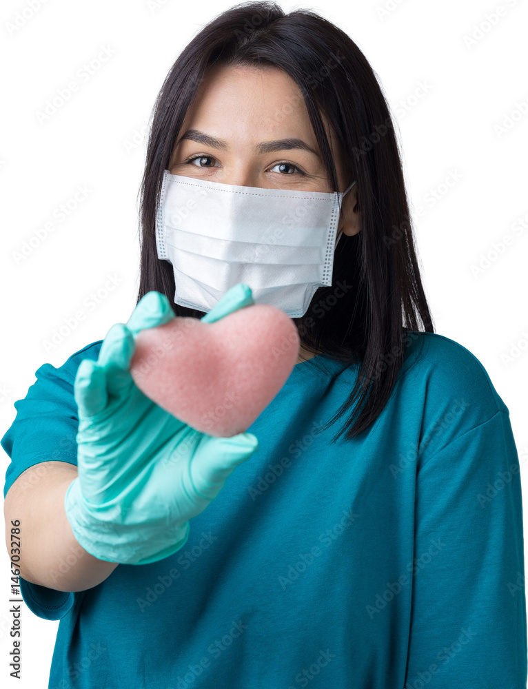 A young brunette girl in a protective medical mask holds a pink heart, symbolizes life. Coronavirus concept. A young brunette girl in a protective medical mask holds a pink heart, symbolizes life. Coronavirus concept.