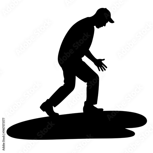 Silhouette of a man bending and reaching on a flat surface  