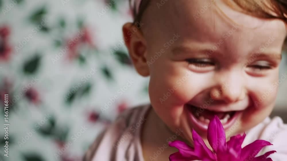 Baby joyfully interacting with pink flower: delightful expressions and innocent playfulness Baby joyfully interacting with pink flower: delightful expressions and innocent playfulness