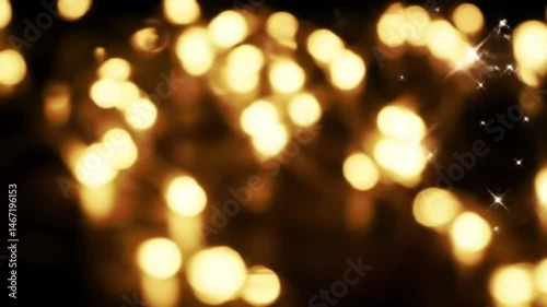 Abstract golden lights with bokeh effect and sparkling stars on a dark blurred background design effect
