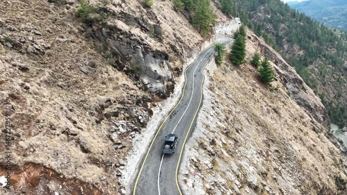 Roads of Nepal. Drone shot revealing mountains, reiver and narrow roads. Drone tracking a car in hilly region Nepal. The way to Rara Lake, Karnali region Nepal.
