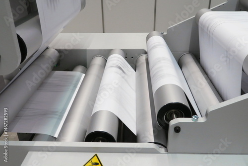 Industrial digital printer at work on reel of paper