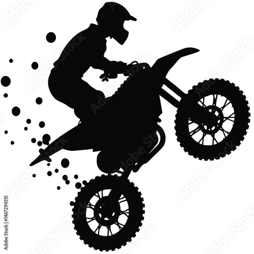 Silhouette of Motocross Rider Performing a Wheelie