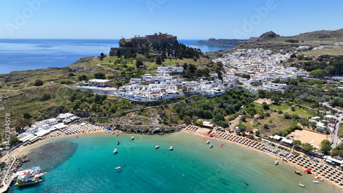 Obraz na płótnie Aerial drone photo of stunning traditional village and medieval archaeological site of Acropolis of Lindos overlooking main beach and Saint Paul's bay, Rhodos island, Dodecanese, Greece w salonie