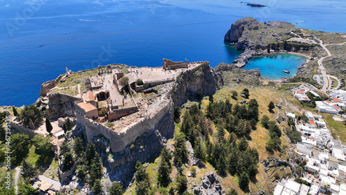 Obraz na płótnie Aerial drone photo of stunning traditional village and medieval archaeological site of Acropolis of Lindos overlooking main beach and Saint Paul's bay, Rhodos island, Dodecanese, Greece w salonie