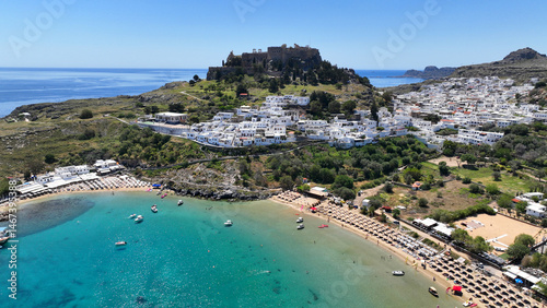 Obraz na płótnie Aerial drone photo of stunning traditional village and medieval archaeological site of Acropolis of Lindos overlooking main beach and Saint Paul's bay, Rhodos island, Dodecanese, Greece w salonie
