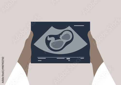 Holding the future with joy and anticipation as the ultrasound reveals the tiny baby image