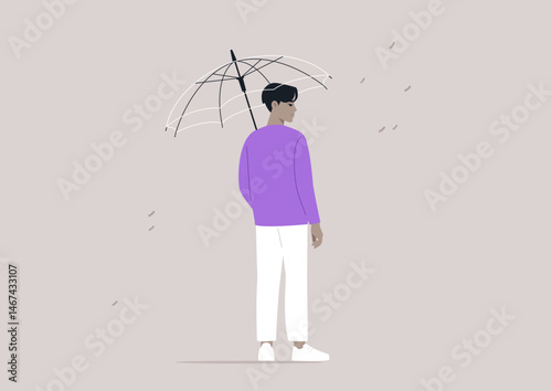 In a quiet urban environment, a person standing under a transparent umbrella as droplets of rain fall around them, fostering a sense of safety amidst the wet weather