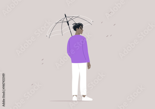 In a quiet urban environment, a person standing under a transparent umbrella as droplets of rain fall around them, fostering a sense of safety amidst the wet weather