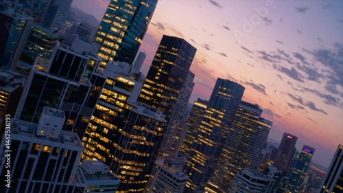 Stunning city skyline at sunset with vibrant colors illuminating skyscrapers and bustling streets. FPV drone